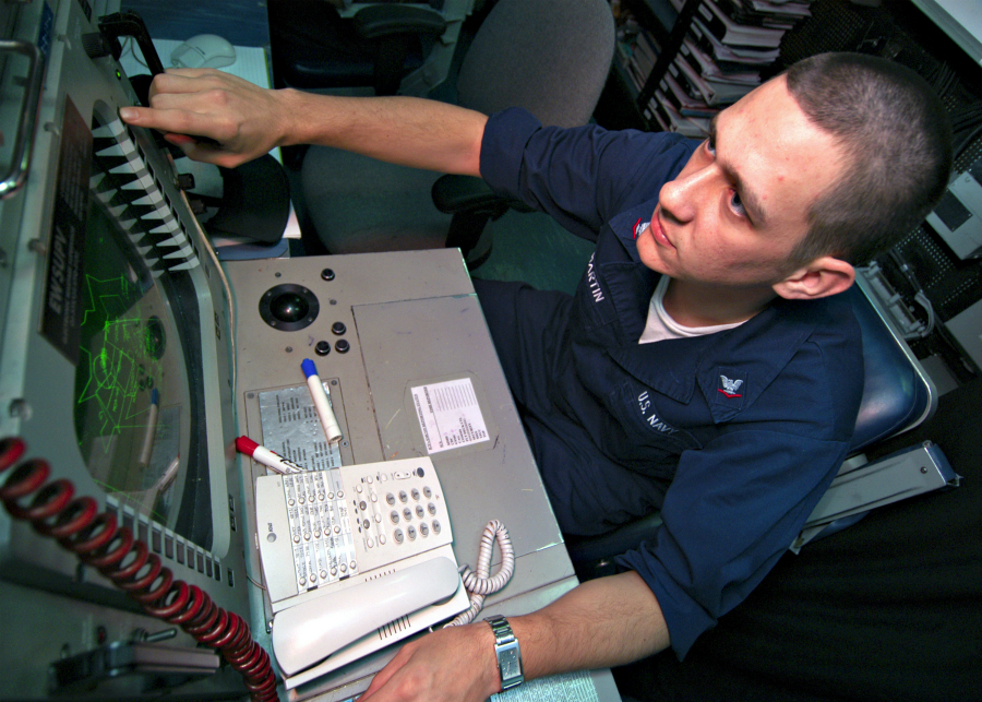 031230-N-9742R-001
Arabian Gulf (Dec. 30, 2003) -- Electronic Warfare Supervisor, Crytpologic Technician 3rd Class Daniel Martin, from Bartlett, Ill., monitors the shipÕs Advanced Combat Direction System console in the Combat Direction Center (CDC) aboard USS Enterprise (CVN 65). The Advanced Combat Direction System provides extended range display, expanded track capacity, Joint Tactical Information Distribution System interoperability, modifiable doctrine, display of mapping information, automatic gridlock, and doctrine-controlled multi-source identification. The Enterprise Carrier Strike Group (ESG) is currently deployed conducting missions in support of Operation Iraqi Freedom and the continued war on terrorism. U.S. Navy photo by Photographer's Mate Airman Milosz Reterski. (RELEASED)