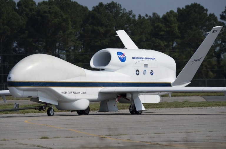 A NASA Global Hawk unmanned aerial vehicle, or drone aircraft, is towed after landing during a Hurricane and Severe Storm Sentinel, or HS3, mission at NASA's Wallops Flight Facility in Wallops Island, Virginia, on September 10, 2013. The HS3 mission uses two of the unmanned aircraft to fly over tropical storms and hurricanes to monitor weather conditions, utlilizing the Global Hawk's ability to fly as high as 19.8 km (12.3 miles), as far as 20,278 km (12,600 miles) and stay in the air for as long as 28 hours. AFP PHOTO / Saul LOEB